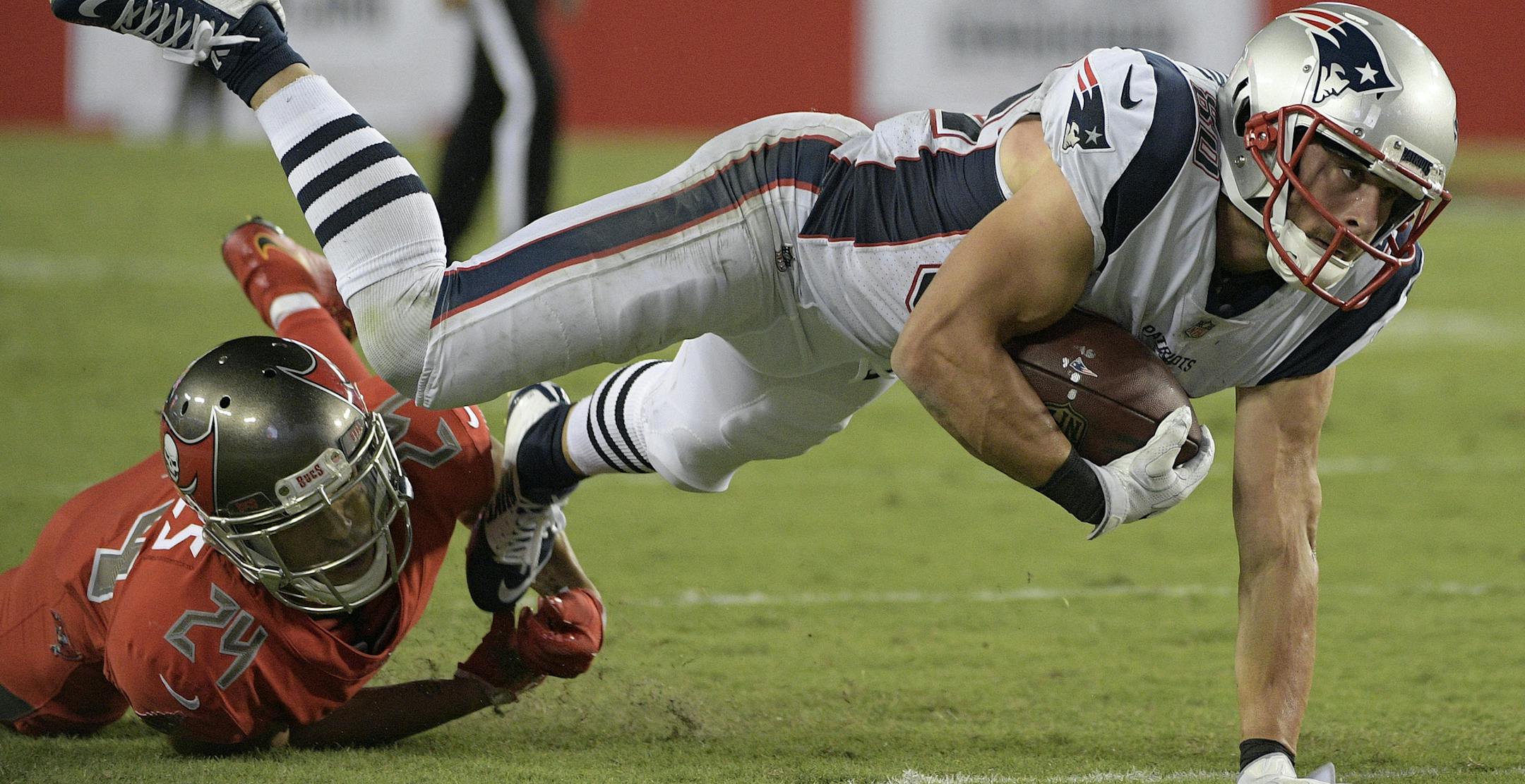 New England Patriots wide receiver Danny Amendola (80) is tripped up Tampa Bay Buccaneers cornerback Brent Grimes (24) during the second quarter of an NFL football game Thursday, Oct. 5, 2017, in Tampa, Fla. (AP Photo/Phelan Ebenhack)