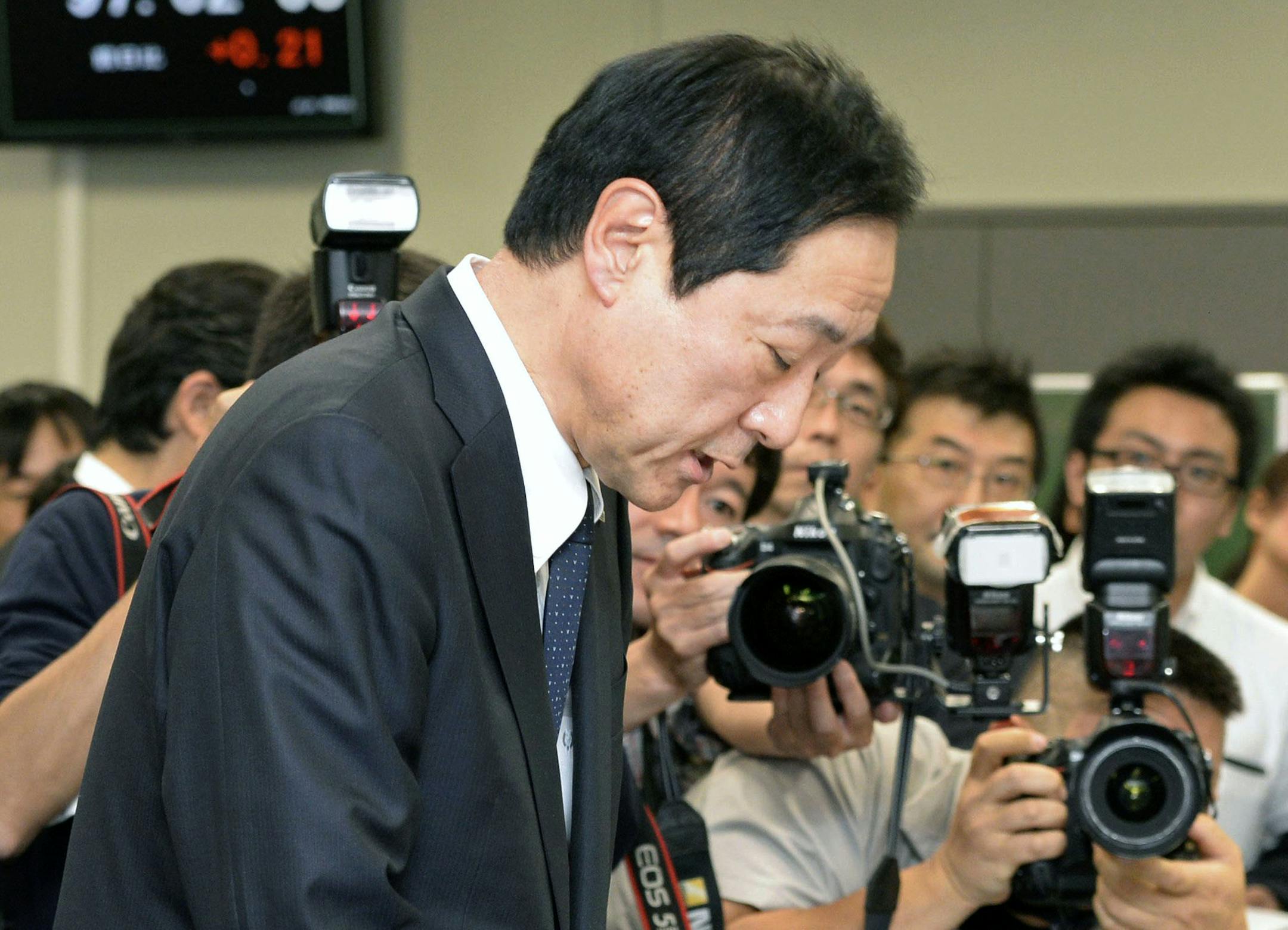 Mizuho Mizuho Financial Group President Yasuhiro Sato bows at the end of a press conference in Tokyo Monday, Oct. 28, 2013. Mizuho said Monday the chairman of its banking business and two other top executives will resign over the Japanese lender's failure to crack down on loans to organized crime. Mizuho said Sato will give up six months of pay but remain at his post. The bank also is appointing Tatsuo Kainaka, a former prosecutor and Supreme Court judge with a reputation for toughness, to be it