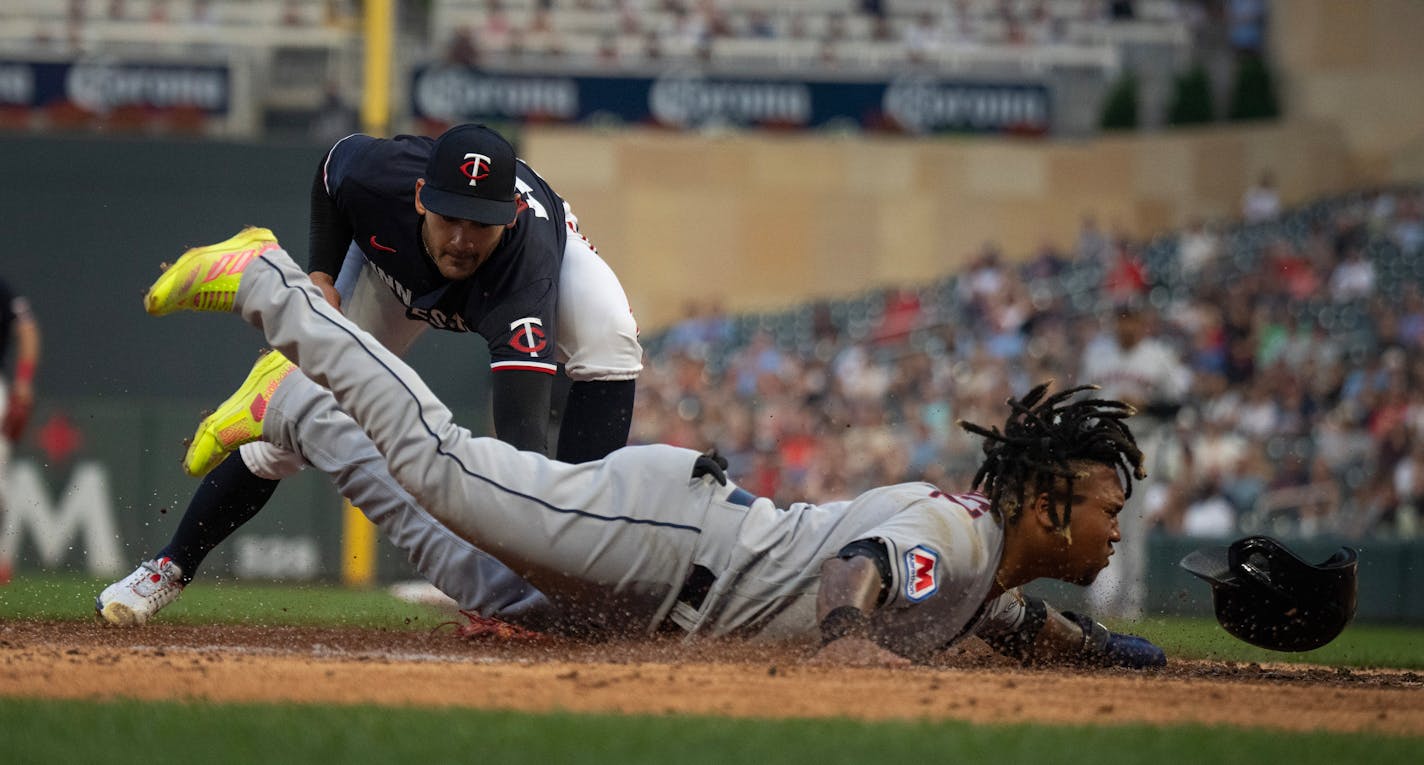 Cleveland Guardians third baseman Jose Ramirez (11) was safe at home as Minnesota Twins starting pitcher Pablo Lopez (49) try to tag him out after a wild pitch in the third inning at Target Field Tuesday August 29.,2023 in Minneapolis, MN. ] JERRY HOLT • jerry.holt@startribune.com