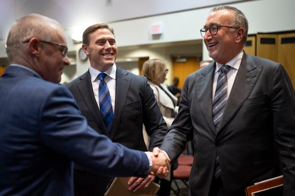 Dr. Jakub Tolar, dean of the University of Minnesota Medical School, left, shook hands with Fairview CEO James Hereford with Sanford CEO Bill Gassen b