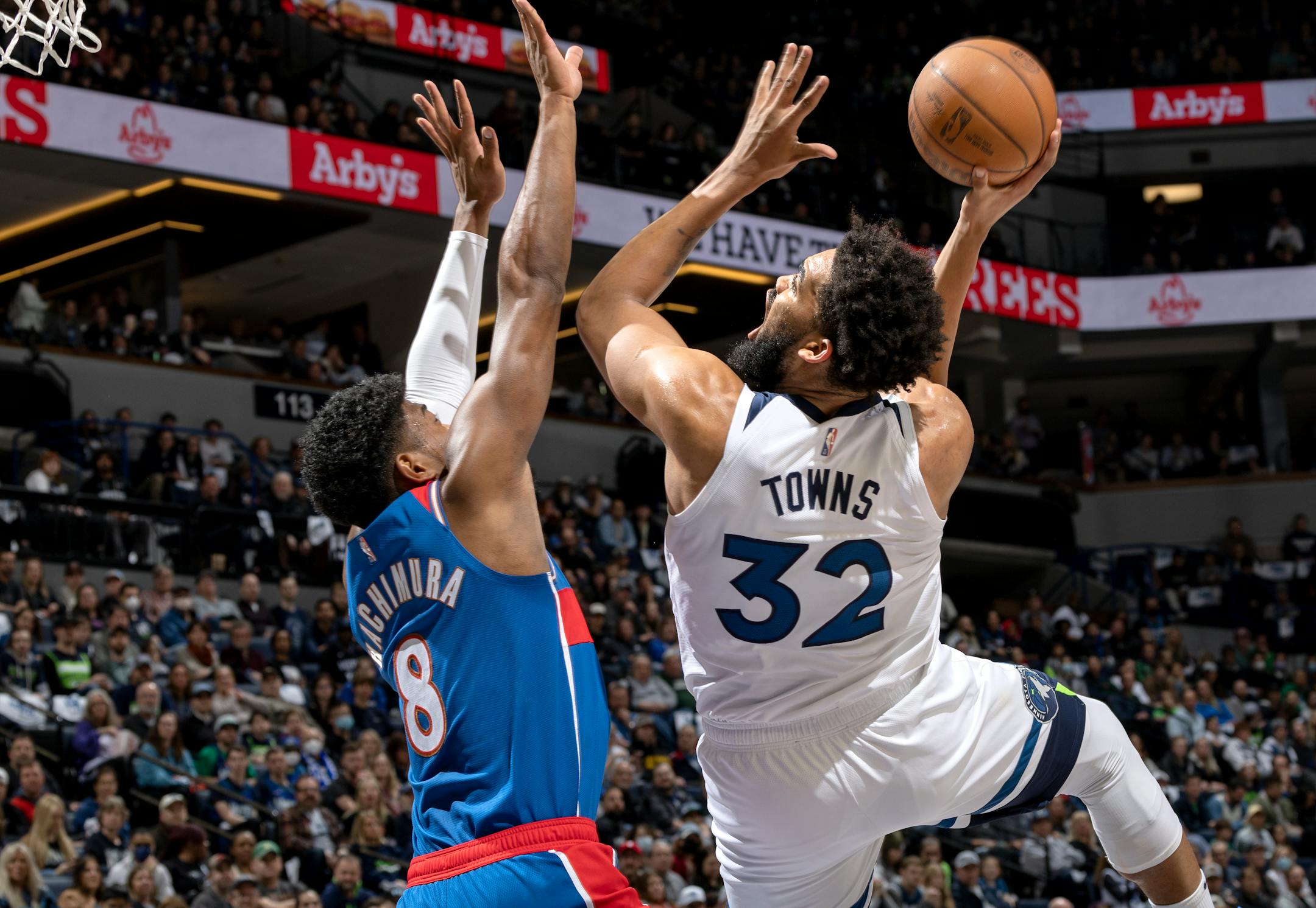 Karl Anthony-Towns (32) of the Minnesota Timberwolves is fouled by Rui Hachimura (8) of Washington Wizards in the first quarter.