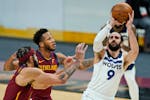 Minnesota Timberwolves' Ricky Rubio, right, shoots against Cleveland Cavaliers' JaVale McGee, left, and Lamar Stevens, center, in the second half of a