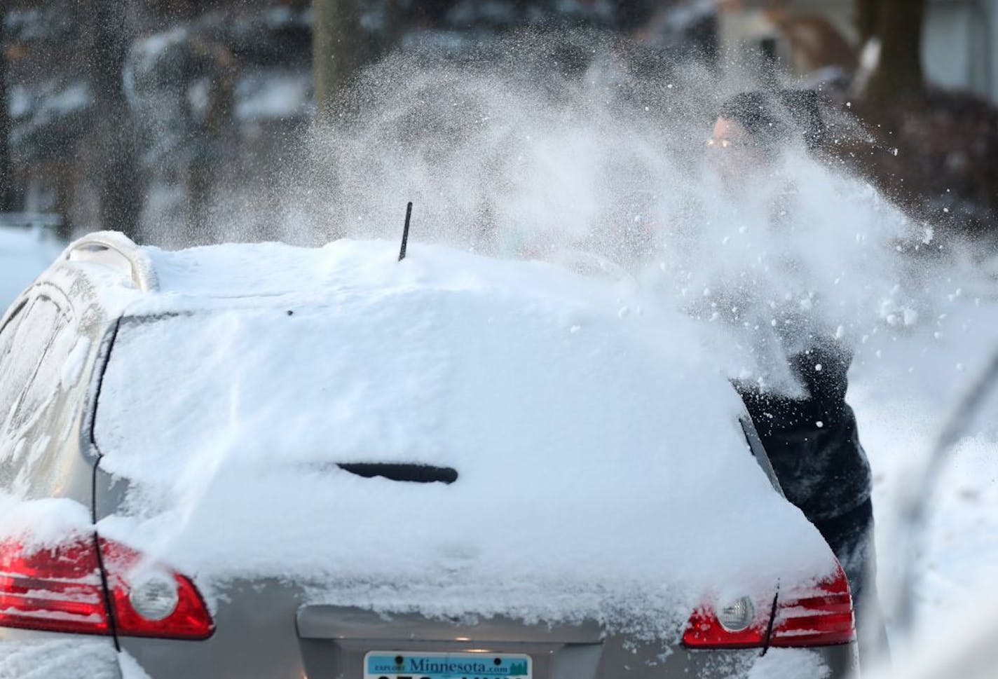 Andrew Schmidt scraped through frozen rain and snow while clearing the windows of his vehicle outside his southeast Minneapolis home Tuesday, Dec. 5, 2017, in Minneapolis, MN.