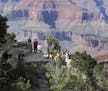FILE - In this Aug. 19, 2015, file photo, visitors gather at an outlook on the South Rim of Grand Canyon National Park in northern Arizona. Democratic