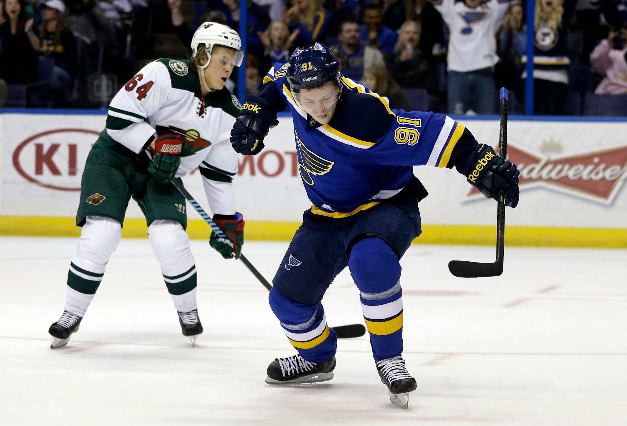St. Louis Blues' Vladimir Tarasenko, right, of Russia, celebrates after scoring as Minnesota Wild's Mikael Granlund, left, of Finland, watches during the second period of an NHL hockey game Saturday, April 11, 2015, in St. Louis. (AP Photo/Jeff Roberson)