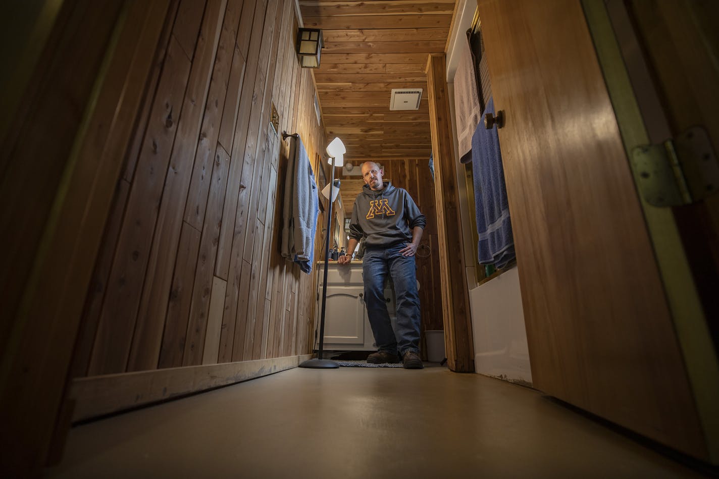 Darrin Lundeen of New Hope in his basement that flooded last year when his solar installer failed to properly connect the system. The sump pump failed to work, and it flooded the basement. (JERRY HOLT/Star Tribune)