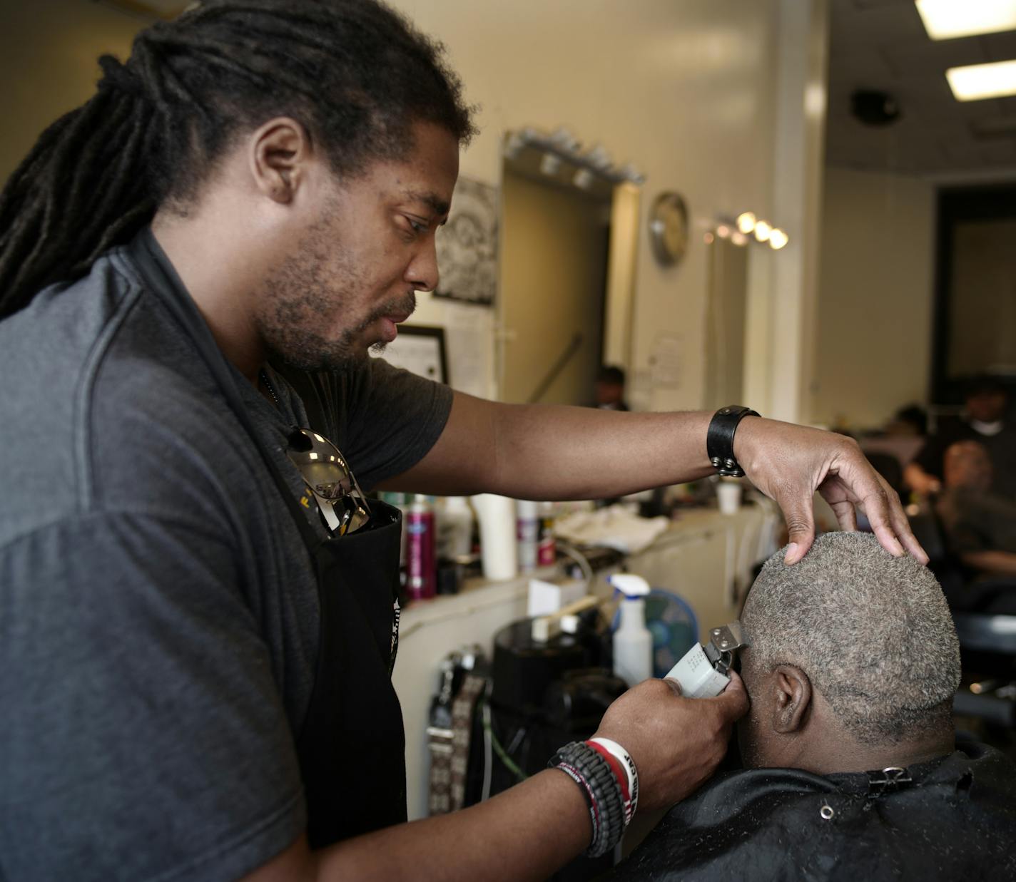 Money Castell, owner of Upper Cuts barbershop gives a client a trim.]A new apartment building in Loring Park will displace a handful of high-profile businesses and the development is sharpening concern over gentrification in the decreasingly scruffy pocket of downtown Minneapolis.Richard Tsong-Taatarii&#xef;rtsong-taatarii@startribune.com