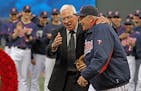 Former Twins manager Tom Kelly, left, laughed with Twins bullpen coach Rick Stelmaszek after Kelly tossed him a ceremonial pitch during the pregame ce