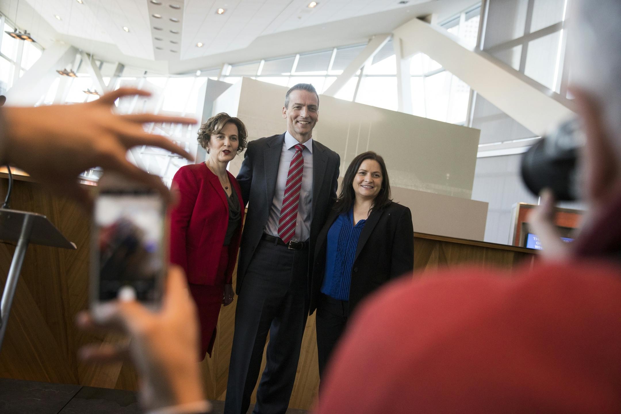 Ed Graff, center, poses for a photo with Minneapolis Mayor Betsy Hodges, left, and Danielle Grant, right, president and CEO of STEP-UP Achieve during a STEP-UP Achieve Partners Breakfast at Target Field.