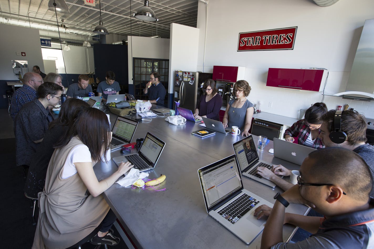 Employees work in the communal kitchen area at the Clockwork office in Minneapolis. ] (Leila Navidi/Star Tribune) leila.navidi@startribune.com BACKGROUND INFORMATION: Tuesday, June 7, 2016 in Minneapolis. Clockwork Active Media once again topped the Top Workplaces list for small businesses.