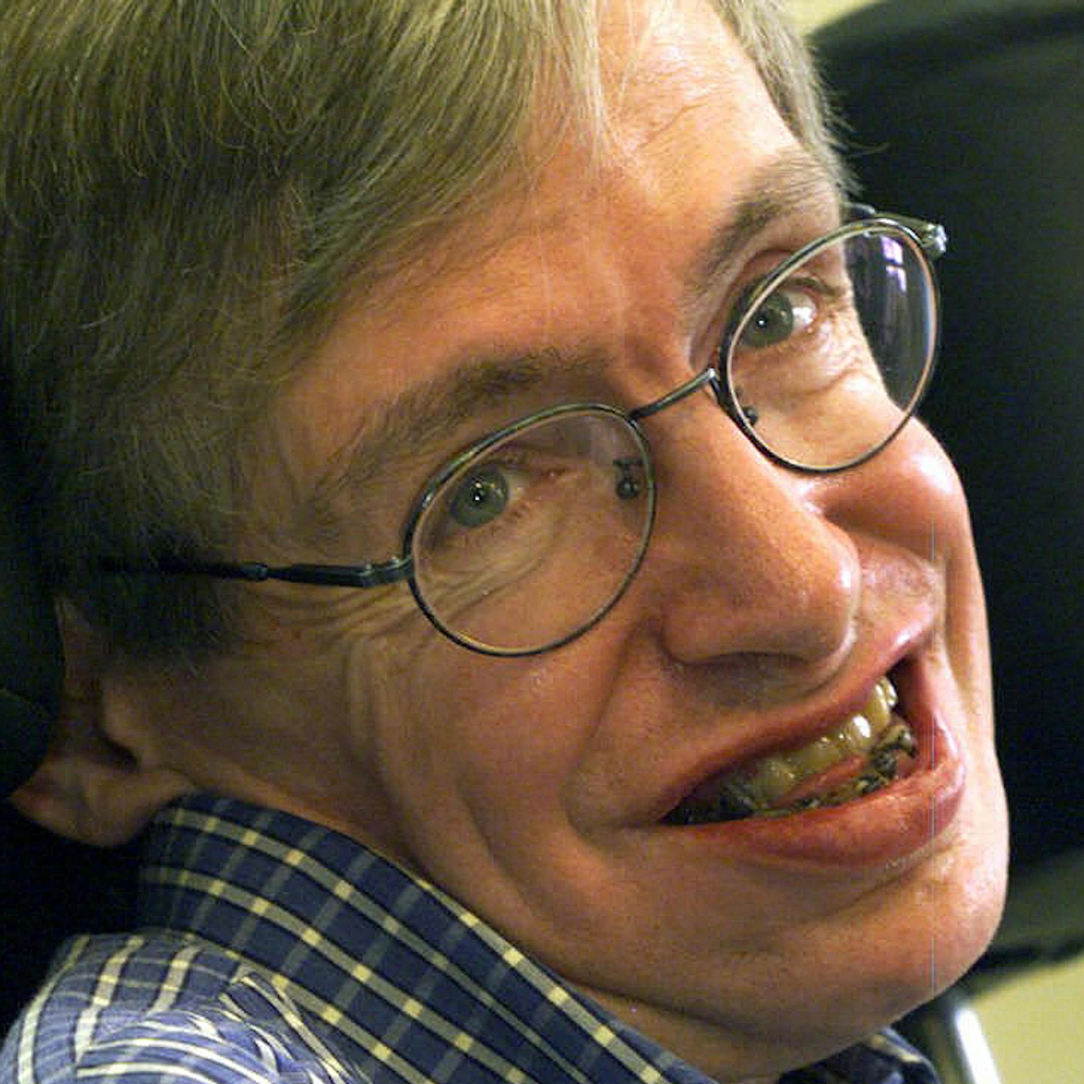 FILE - In this Wednesday, July 21, 1999 file photo Professor Stephen Hawking smiles during a news conference at the University of Potsdam, near Berlin, Germany. Hawking, whose brilliant mind ranged across time and space though his body was paralyzed by disease, has died, a family spokesman said early Wednesday, March 14, 2018.(AP Photo/Markus Schreiber, File)