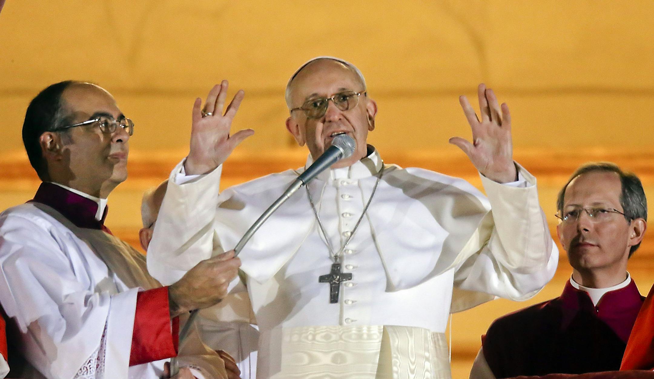 FILE -- In this file photo taken on March 13, 2013, Pope Francis waves to the crowd from the central balcony of St. Peter's Basilica at the Vatican, the day of his election. From his gestures to his simple soundbites to his emphasis that priests are called to serve, Pope Francis has endeared himself to the public, radically shifted the paradigm of the papacy and reminded the world that the church's mission is one of mercy. (AP Photo/Gregorio Borgia)
