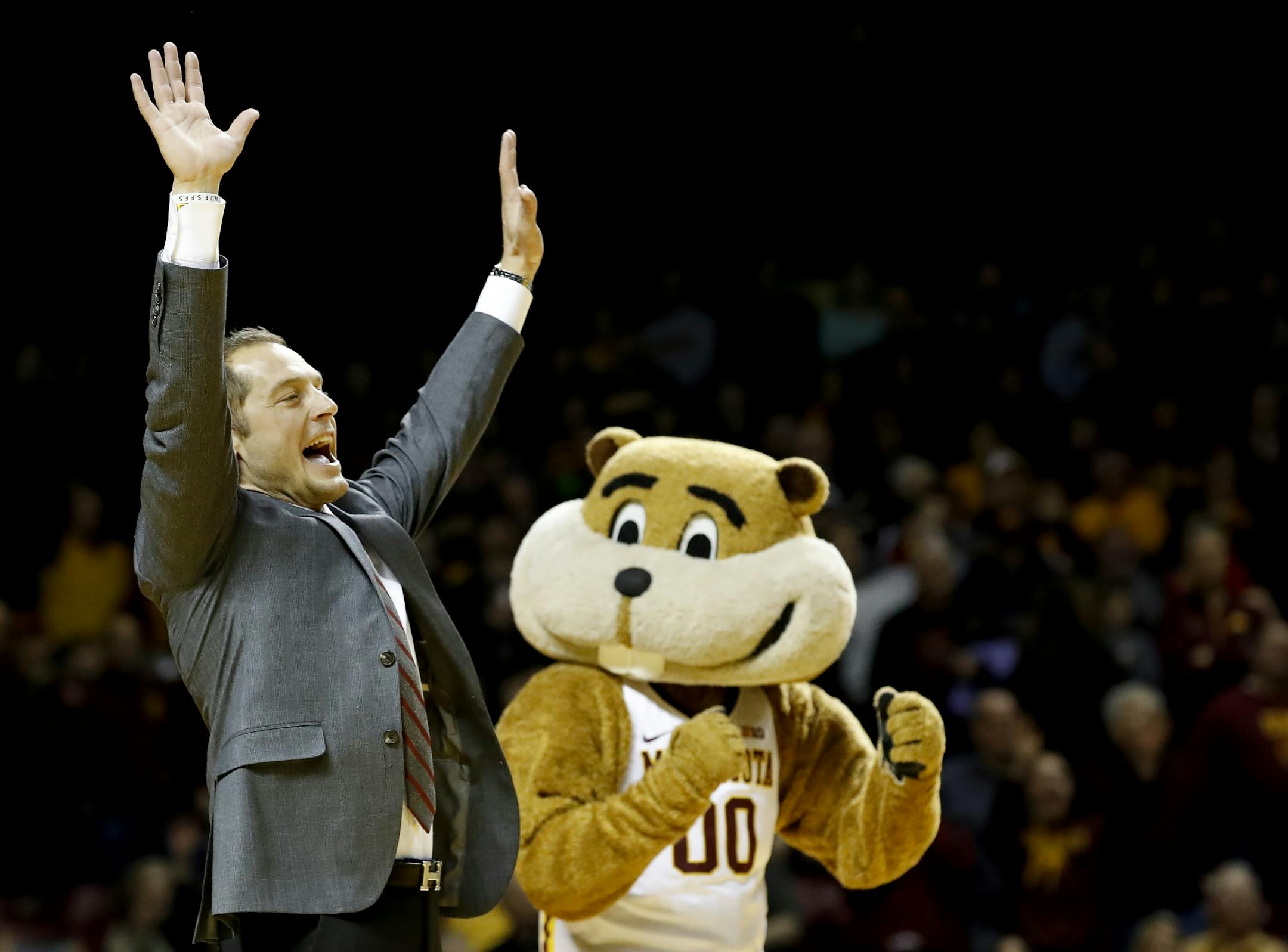 Minnesota Gophers head football coach P.J. Fleck addresses the crowd and helped the half time entertainment act Red Panda at William Arena.