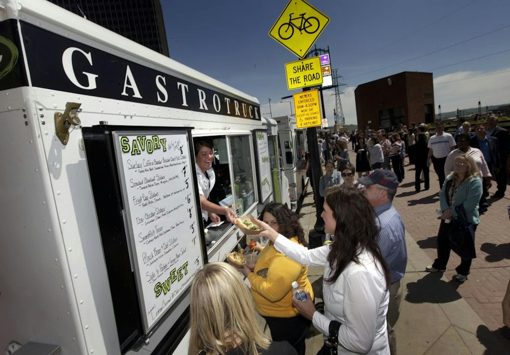 The Gastro truck, Cathrine Eckers hands lunch to customer, Crystal Seelhammer.