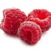 Ripe red raspberries isolated on white background. From istock