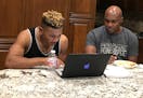 Antoine Winfield and his son, Antoine Winfield Jr., review game film together at their home in 2015.