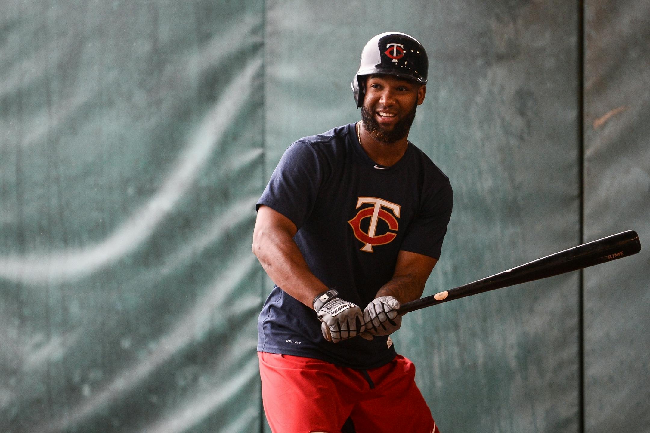 Minnesota Twins outfielder Danny Santana (39) laughed between pitches in the bullpen Wednesday. Batters worked on tracking pitches Wednesday after being forced to move inside due to rain.