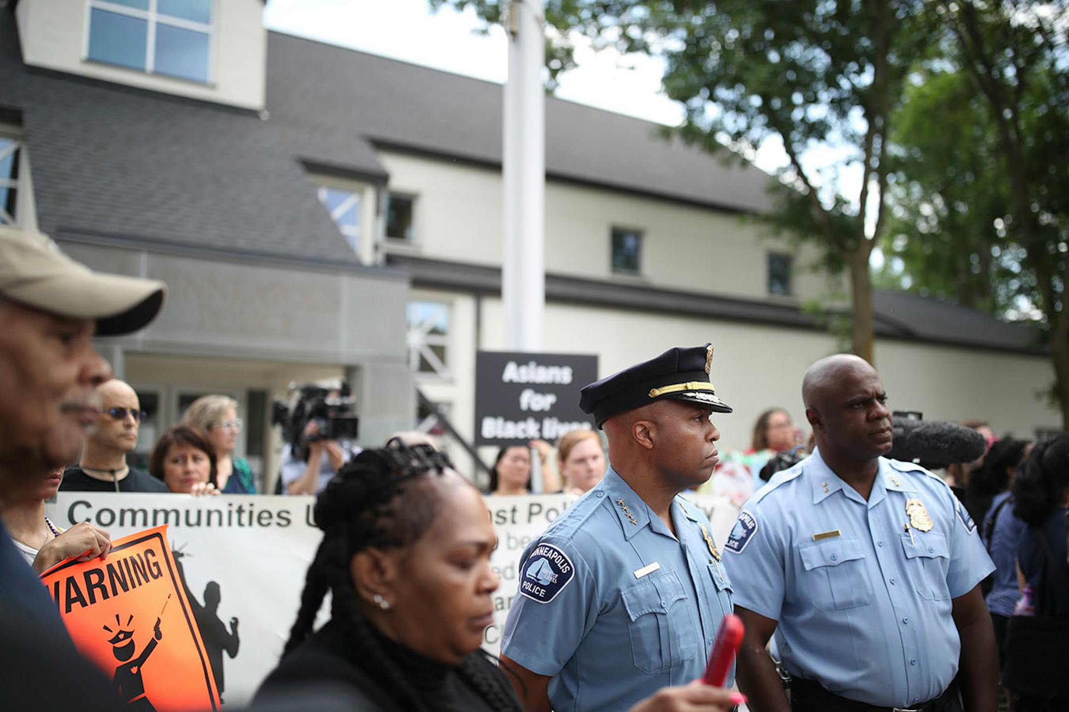Minneapolis Police Chief Medaria Arradondo, second from right, listened as north side community members held a protest and rally at the Fourth Precinct on Plymouth Avenue in response to the shooting death of Thurman Blevins by Minneapolis Police.