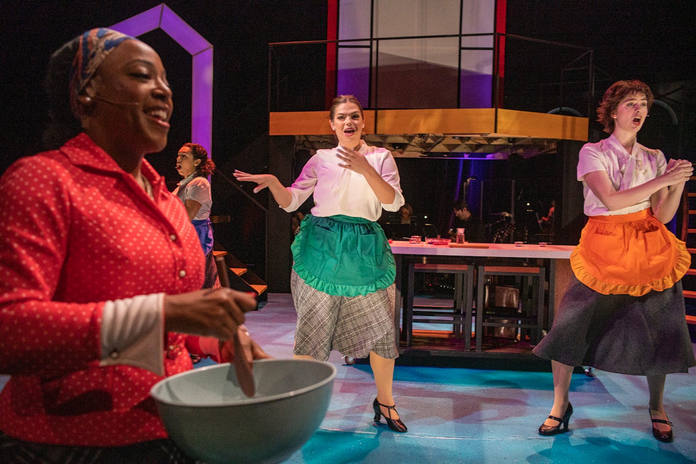 Lynnea Doublette, passes by as Camryn Buelow and Olivia Kemp dance off in the Hamburger Helper scene in St. Paul, Minn., on Sunday, Nov. 19, 2023. For a century, Betty Crocker has been an icon of womanhood, motherhood, and home. "I am Betty," a new musical, explores the General Mill's corporate spokesmodel that began as a signature on letters then became a homemaker dishing out recipes before becoming, in contemporary times, a spoon. ] RICHARD TSONG-TAATARII • richard.tsong-taatarii @startribune.com