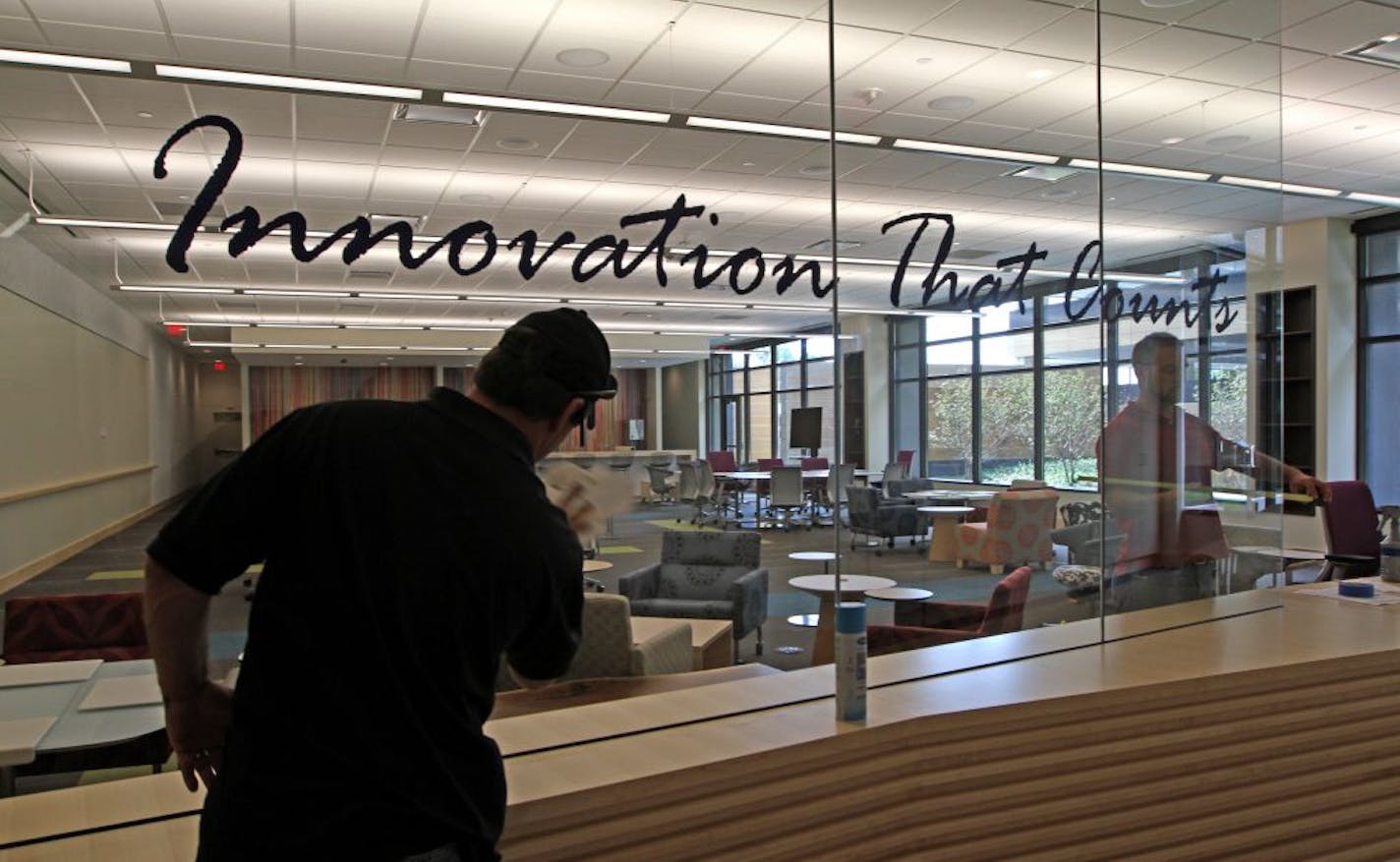 Workmen put the finishing touches on the Innovation Center at the new United Healthcare building in Minnetonka. United Healthcare, the benefits business of United Health Group, has opened a new headquarters building in Minnetonka, at 9700 Health Care Lane. The health care conglomerate has been on an expansion tear of late, completing this state-of-the-art structure, and embarking on other projects in Eden Prairie. This building consolidates operations across Hwy. 100 in Edina into one facility.