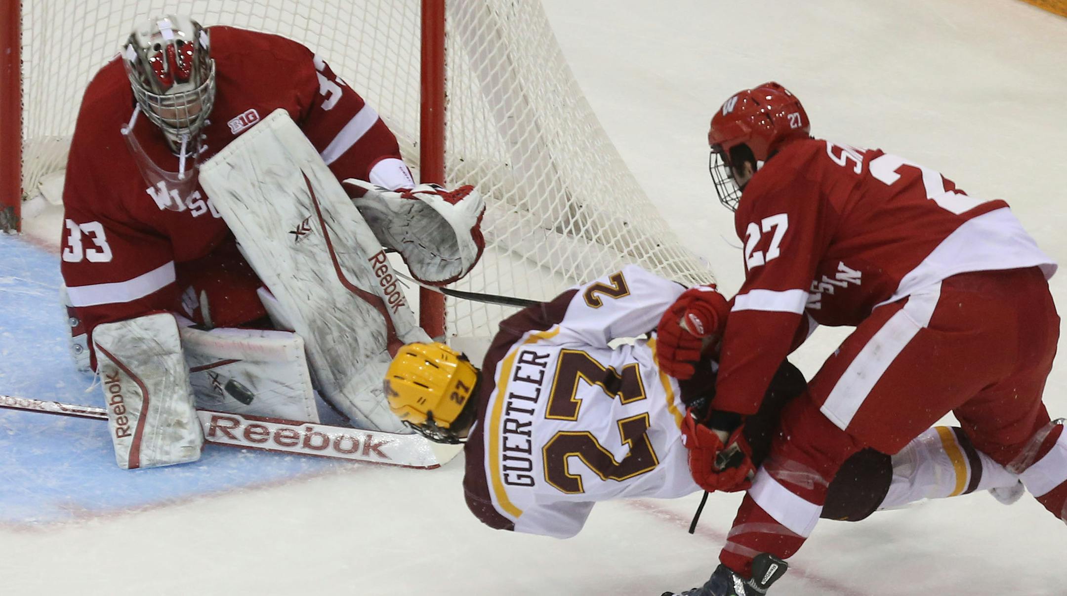 Gophers Gabe Guertler attempted to score while in mid air on Wisconsin's goalie Joel Rumpel during the first period at Mariucci Arena in Minneapolis, Min., Saturday, November 30, 2013. ] (KYNDELL HARKNESS/STAR TRIBUNE) kyndell.harkness@startribune.com