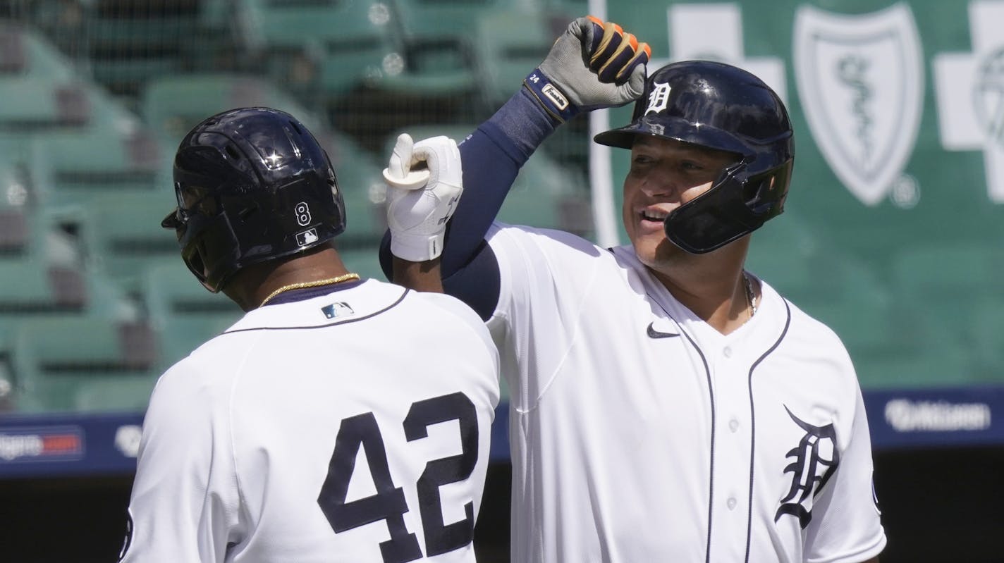 Detroit Tigers' Jonathan Schoop, left, is greeted by Miguel Cabrera after hitting a solo home run on Minnesota Twins starting pitcher Kenta Maeda during the sixth inning of a baseball game, Sunday, Aug. 30, 2020, in Detroit. (AP Photo/Carlos Osorio)