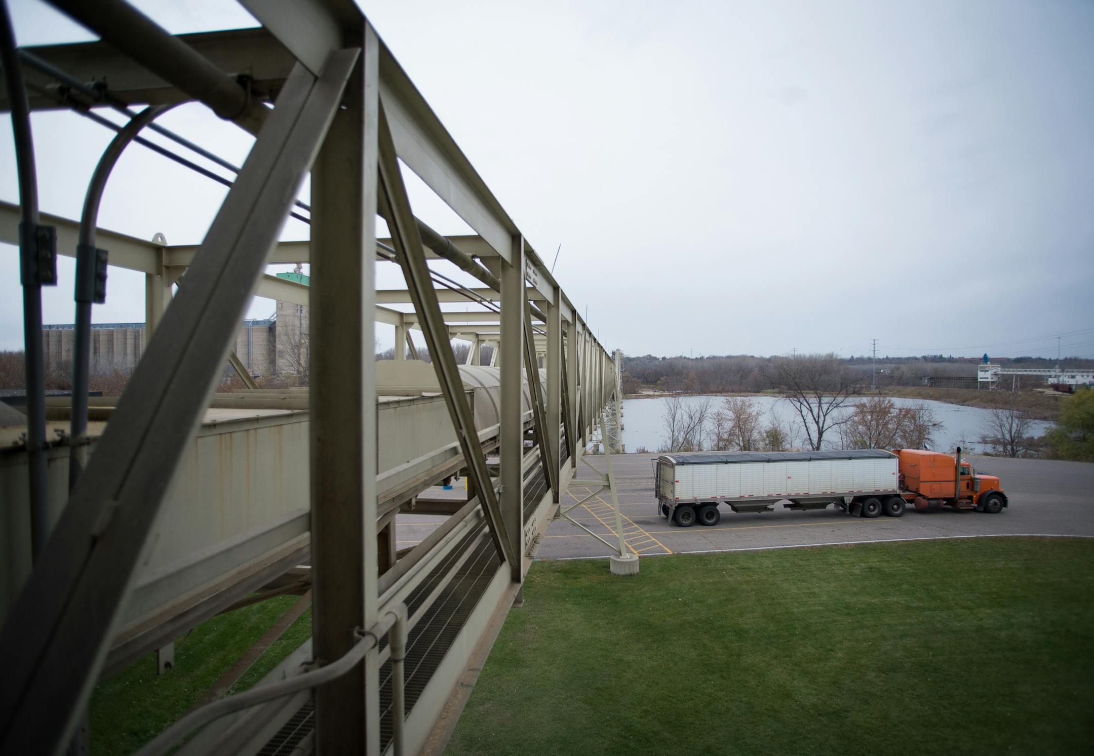 A truck passes under CHS's quarter-mile long conveyor belt Friday morning. The conveyor moves grain from the truck terminal to a river barge loading facility across the Minnesota River. ] AARON LAVINSKY • aaron.lavinsky@startribune.com Photographing the process of unloading grain from trucks onto river barges at the CHS Grain Terminal in Savage on Friday, November 7, 2014.