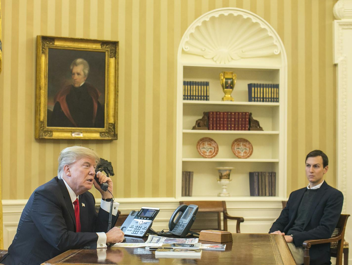 President Donald Trump, accompanied by Jared Kushner, a senior adviser to the president, speaks on the phone with King Salman of Saudi Arabia, in the Oval Office of the White House in Washington, Jan. 29, 2017. (Al Drago/The New York Times)