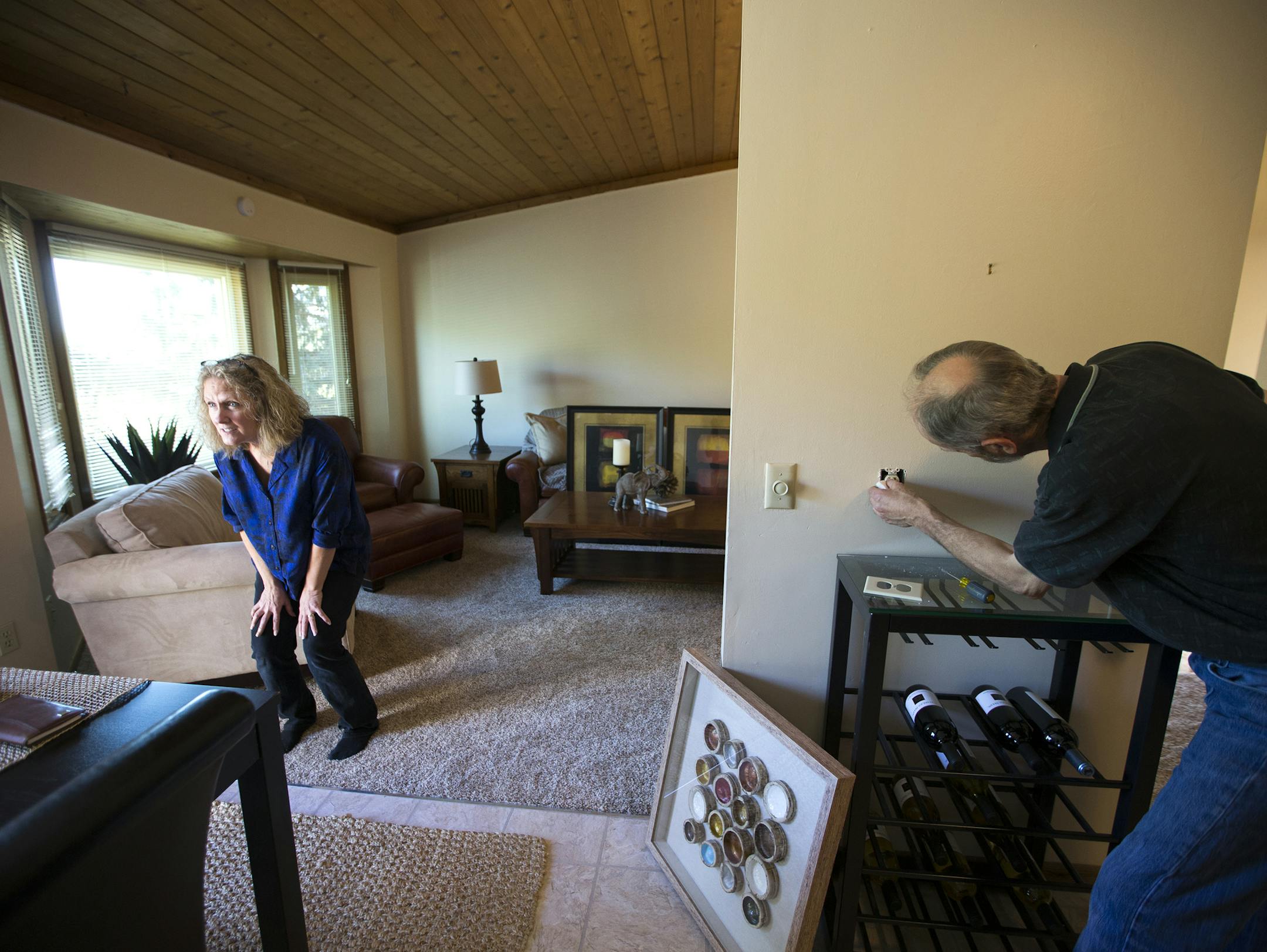 Anita Rockwell, left, and her husband Tom Rockwell of StageWorks stage a home that will go on the market the next day in Lakeville. ] (Leila Navidi/Star Tribune) leila.navidi@startribune.com BACKGROUND INFORMATION: Tuesday, May 17, 2016 in Lakeville. For Twin Cities home buyers, the spring frenzy continues. With buyers outpacing sellers in many areas, prices increased nearly 8 percent, according to a monthly report released Tuesday morning by the Minneapolis Area Association. Anita Rockwell of S