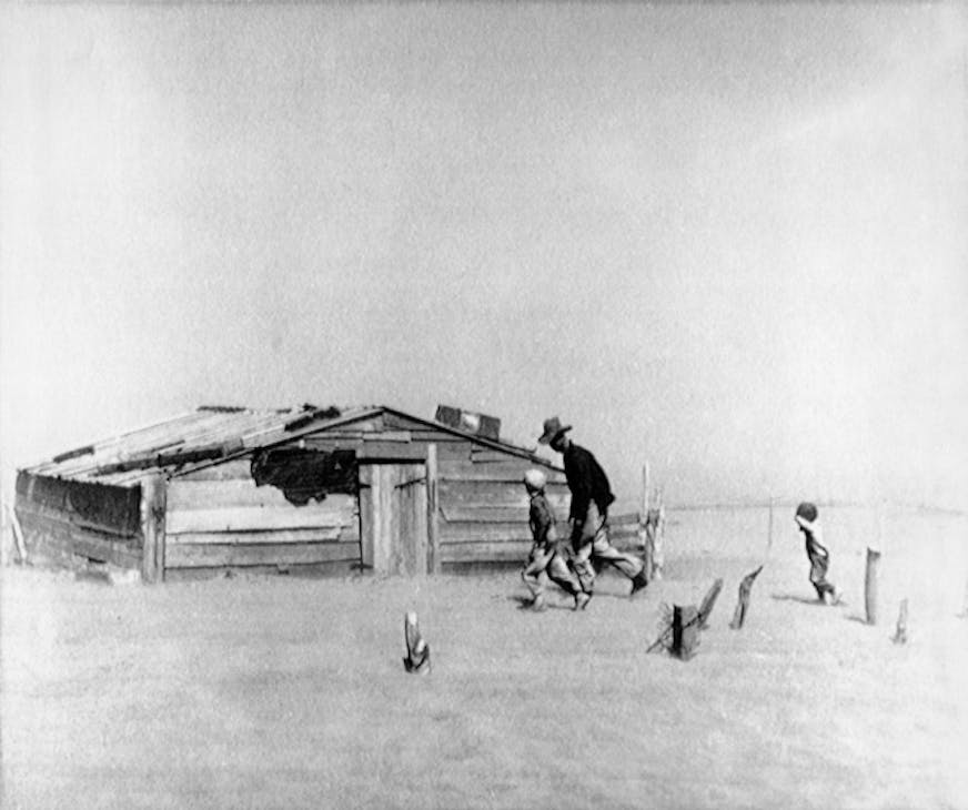 A farmer and his sons battle the wind and struggle for shelter in this 1936 photo of the Dust Bowl taken in Oklahoma by Arthur Rothstein. // Dust bowl, depression, environment, weather //