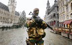 A Belgium police officer patrols the Grand Place in central Brussels, Belgium, Tuesday, Nov. 24, 2015. Brussels keeps its terror alert on highest leve