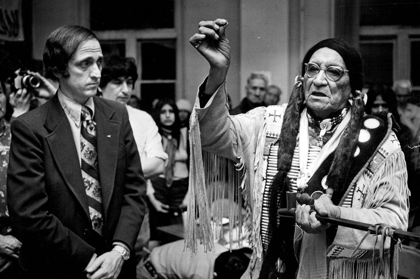 February 12, 1974 Peace! -- St. Paul Mayor Lawrence Cohen and Frank Fools Crow, Kyle, S.D., Pine Ridge Reservation sun dance chief, participated in peacepipe ceremonies at AIM headquarters, 553 Aurora Av., St. Paul, last night on the eve of the opening of the Wounded Knee trial in St. Paul. February 11, 1974 Jack Gillis, Minneapolis Star Tribune