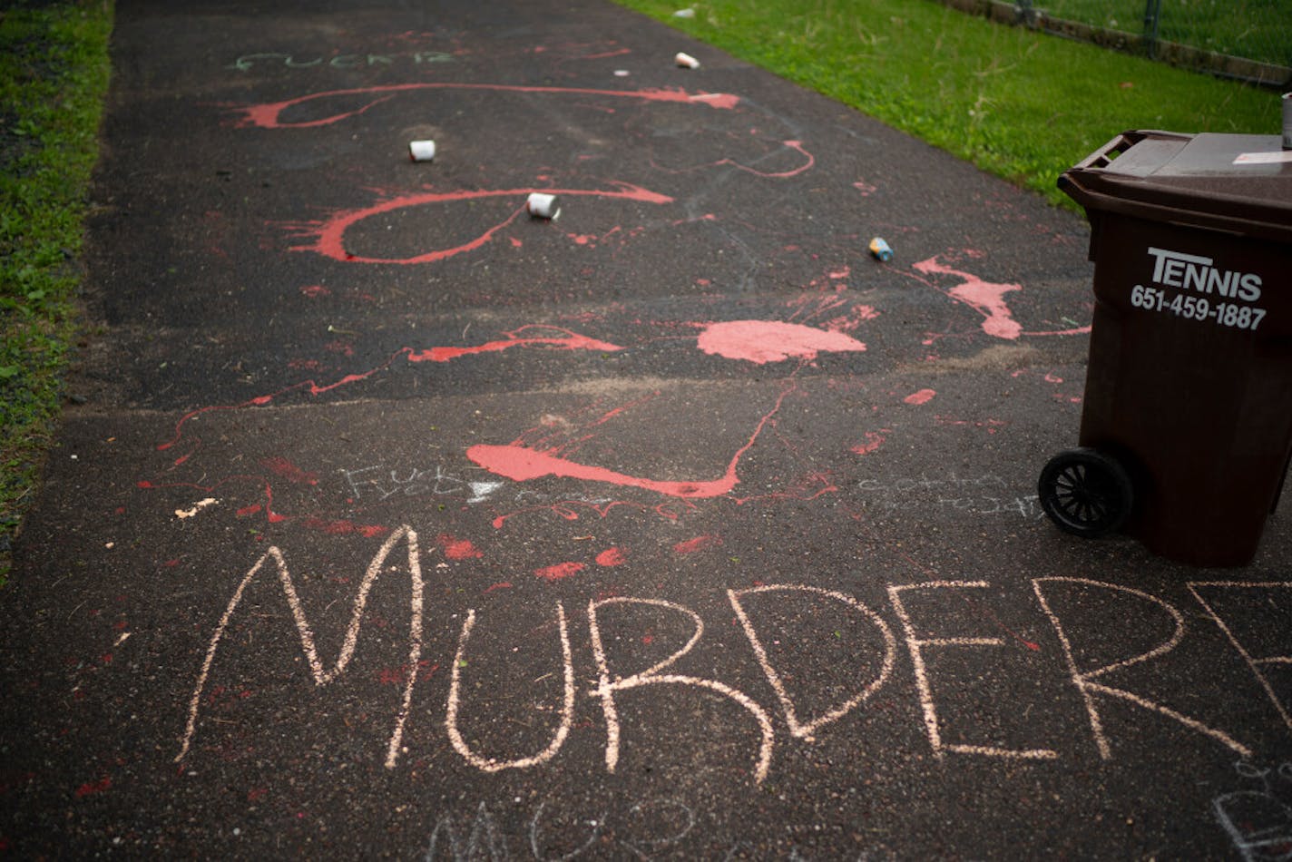 Splattered paint and chalk writing marked the driveway at the home of fired Minneapolis police officer Derek Chauvin in Oakdale on Wednesday evening.