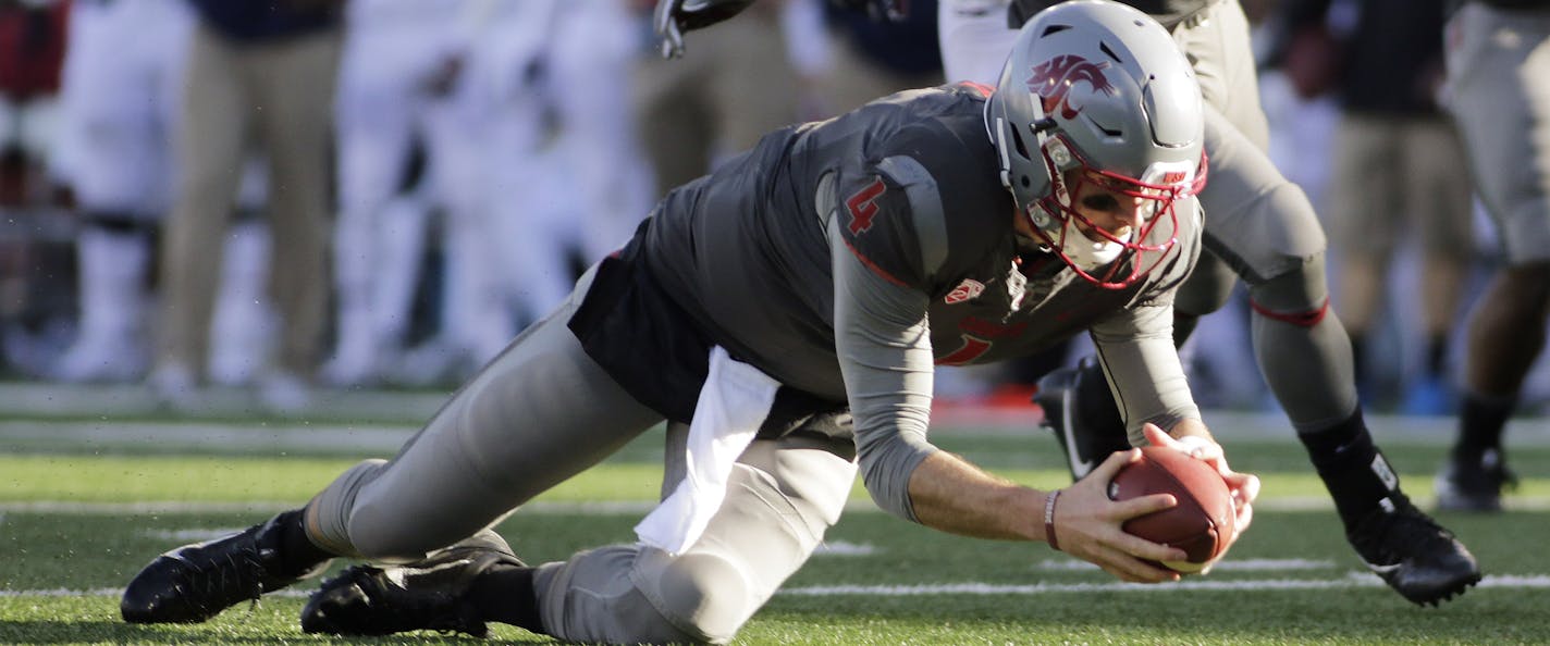 Washington State quarterback Luke Falk (4) recovers a high snap during the second half of an NCAA college football game against Arizona in Pullman, Wash., Saturday, Nov. 5, 2016. (AP Photo/Young Kwak) ORG XMIT: OTK