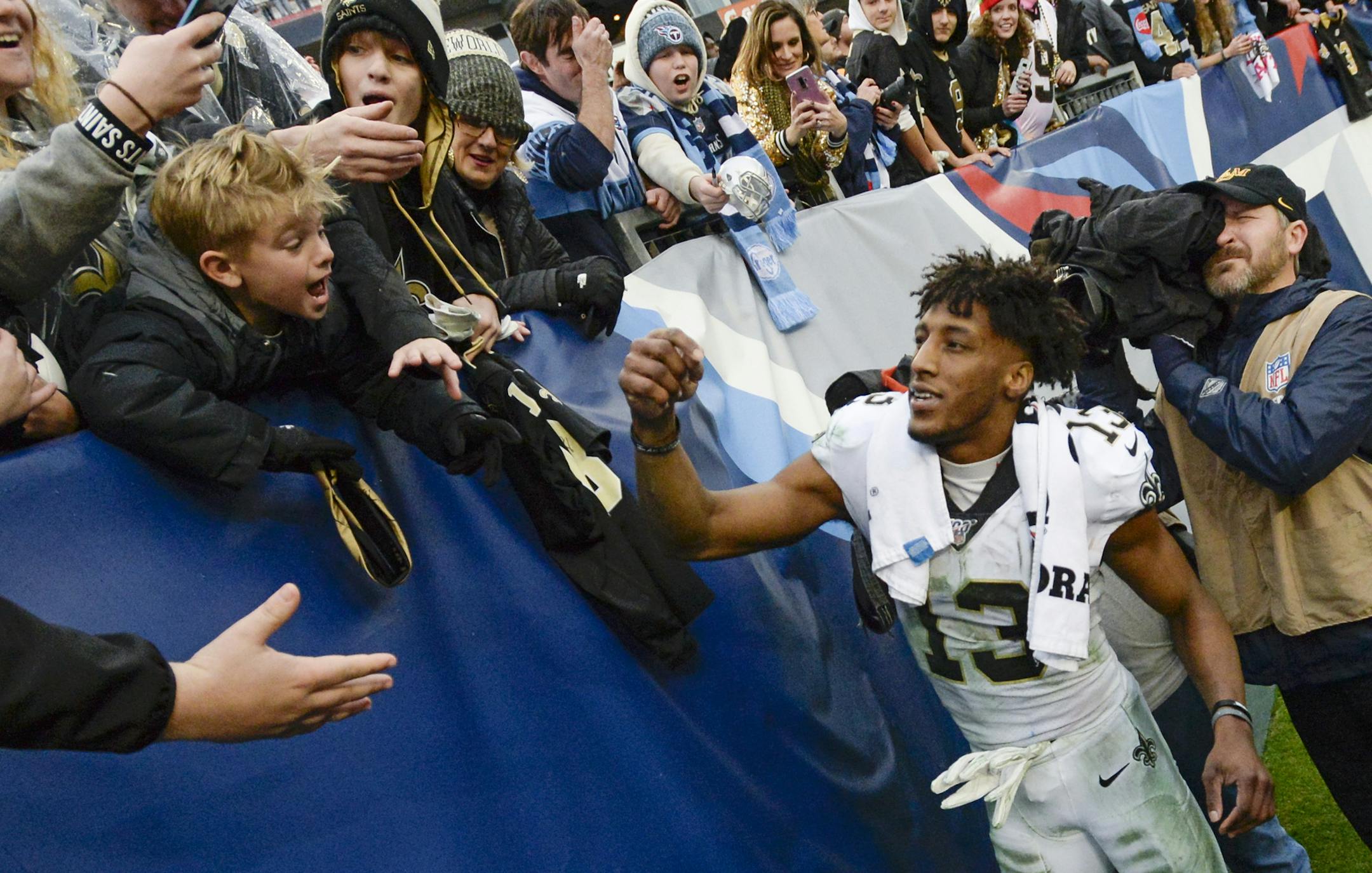 New Orleans Saints wide receiver Michael Thomas signs autographs after an NFL football game against the Tennessee Titans Sunday, Dec. 22, 2019, in Nashville, Tenn. The Saints won 38-28. (AP Photo/Mark Zaleski)