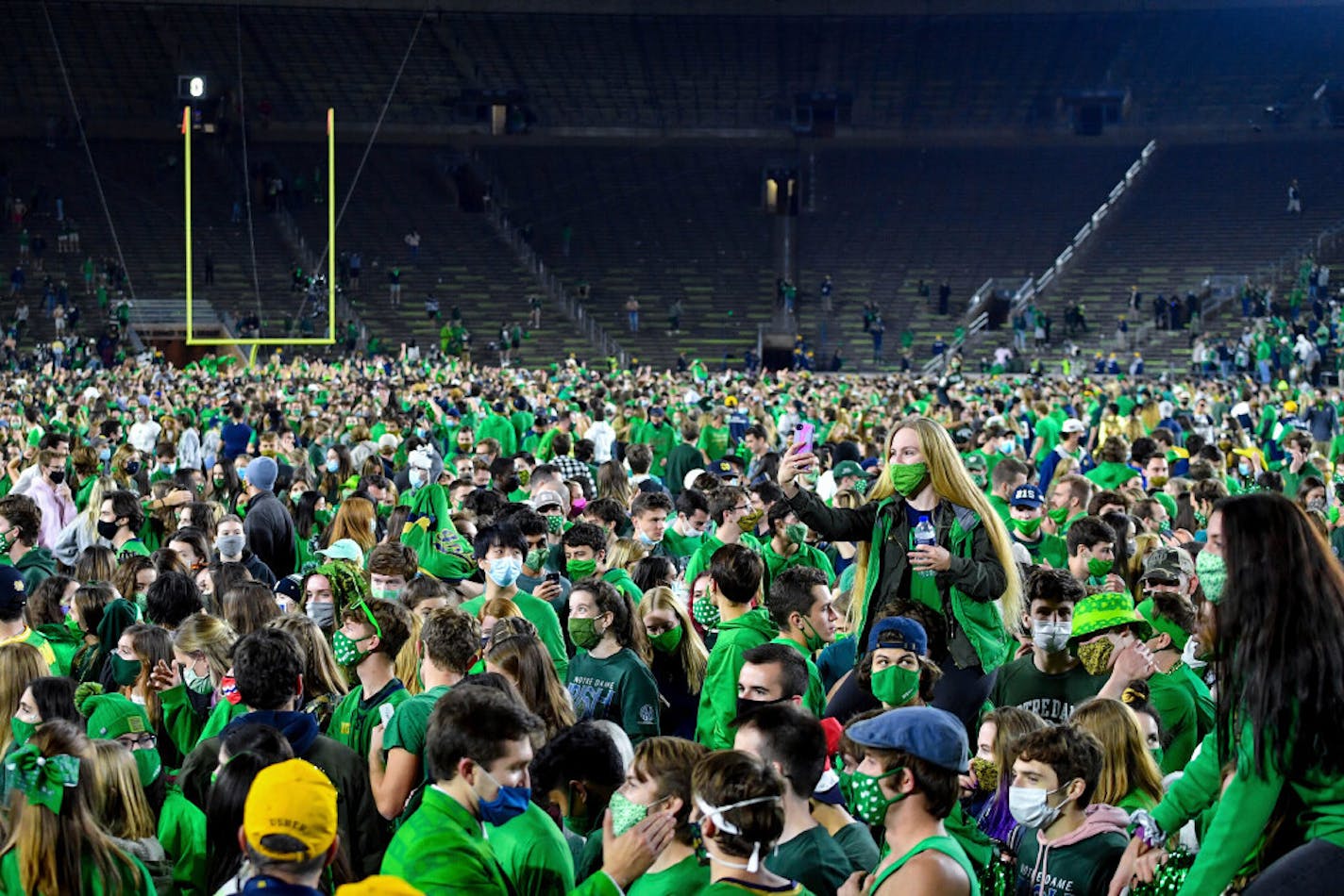 Fans storm the field after Notre Dame defeated the Clemson 47-40 in two overtimes.