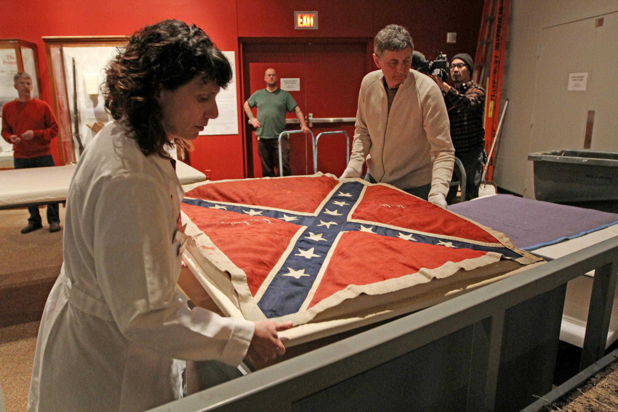(left to right) Ann Frisina and Frank Paraday, Minnesota History Center staff, placed the battle flag captured from the 28th Virginia Infantry at Pickett's Charge during the last day of the Battle of Gettysburg, part of the new Civil War exhibit opening March 2nd 2013, at the Minnesota History Center. Bruce Bisping/Star Tribune bbisping@startribune.com Ann Frisina, Frank Paraday/source. ORG XMIT: MIN1302161638203512