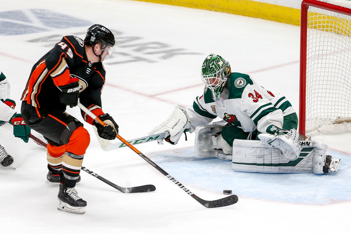 Minnesota Wild goalie Kaapo Kahkonen (34) defends as Anaheim Ducks forward Max Jones (49) shoots during the third period of an NHL hockey game Saturday, Feb. 20, 2021, in Anaheim, Calif. The Wild won 5-1. (AP Photo/Ringo H.W. Chiu)