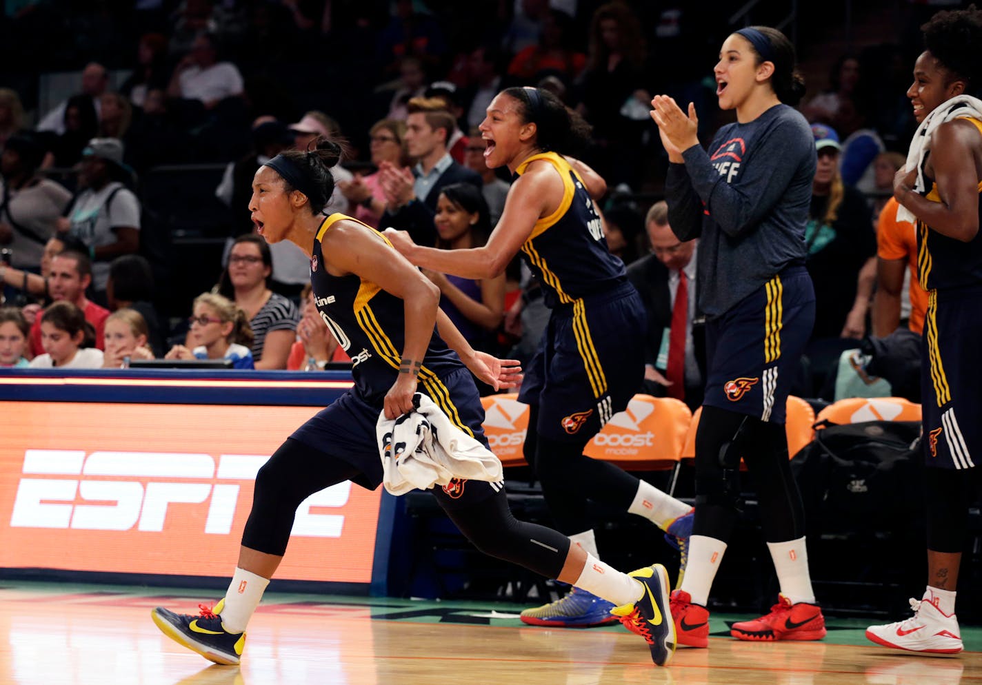 Indiana guard Briann January, left, led the celebration after the Fever defeated the New York Liberty in Game 3 of the WNBA Eastern Conference Finals at Madison Square Garden in New York on Tuesday. The Fever won 66-51 and will take on the Lynx in the WNBA Finals.