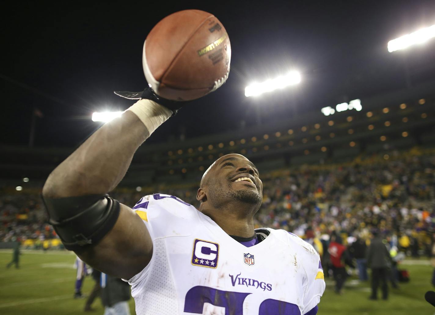 Vikings running back Adrian Peterson (28) held one of the game ball aloft as he walked off the field after the Vikings win Sunday night. ] JEFF WHEELER &#xef; jeff.wheeler@startribune.com The Minnesota Vikings beat the Green Bay Packers 20-13 in the final regular season game of season Sunday, January 3, 2016 at Lambeau Field in Green Bay, WI. ORG XMIT: MIN1601032252110130