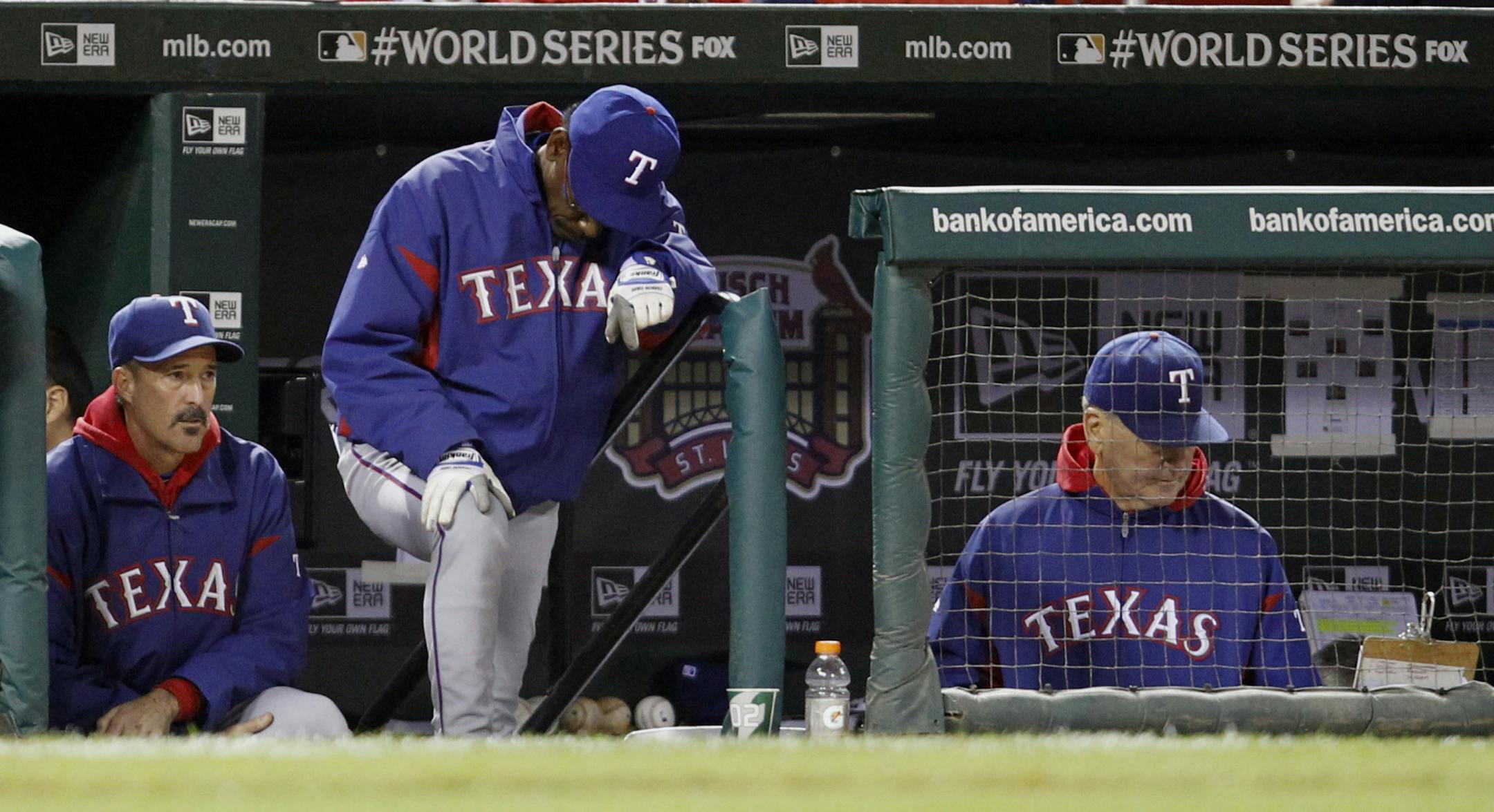 Texas Rangers manager Ron Washington, center, and coaches Mike Maddux, left, and Jackie Moore during the 2011 World Series