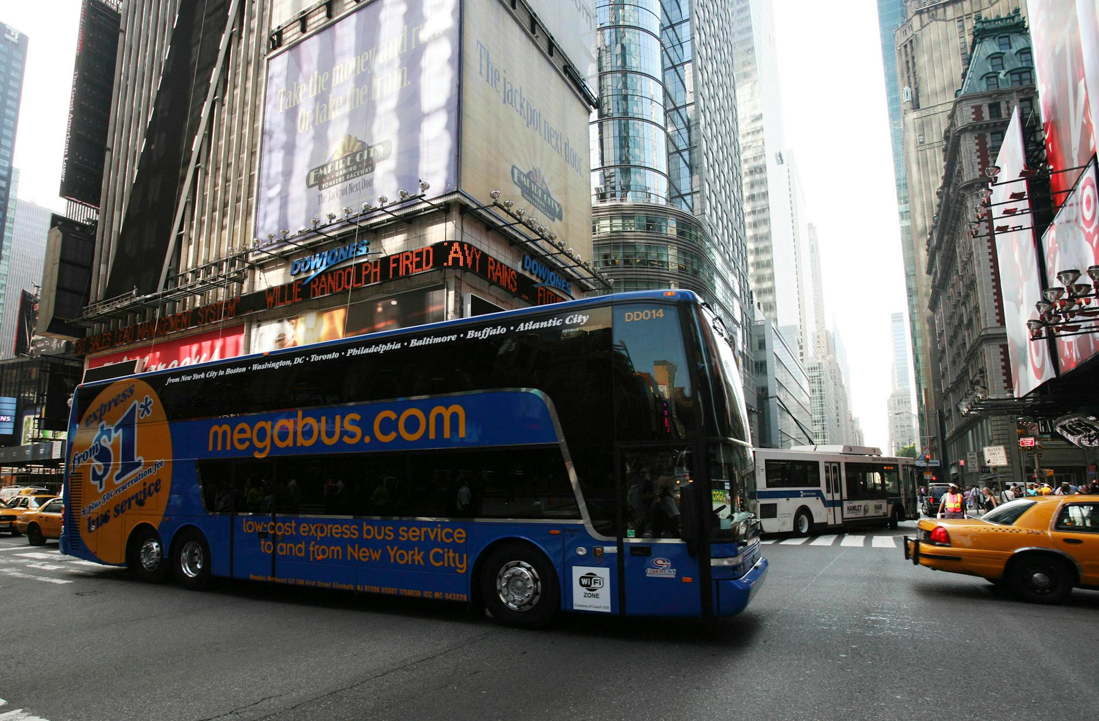 In this June 17, 2008 file photo, a Megabus double-decker bus drives through New York's Times Square to inaugurate its service to the northeast. Once considered the travel choice of last resort, some say the confluence of rising gas prices, airline headaches and the rise of discount carriers is creating a kind of renaissance in the bus industry.