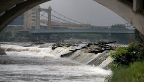 Recent statewide heavy rains have left the Mississippi River in the metro swollen with water, including here at Horeshoe Dam, beneath the Third Avenue