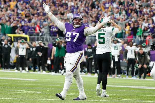 Minnesota Vikings defensive tackle Harrison Phillips (97) reacts in front of New York Jets quarterback Mike White (5) after a defensive stop during th