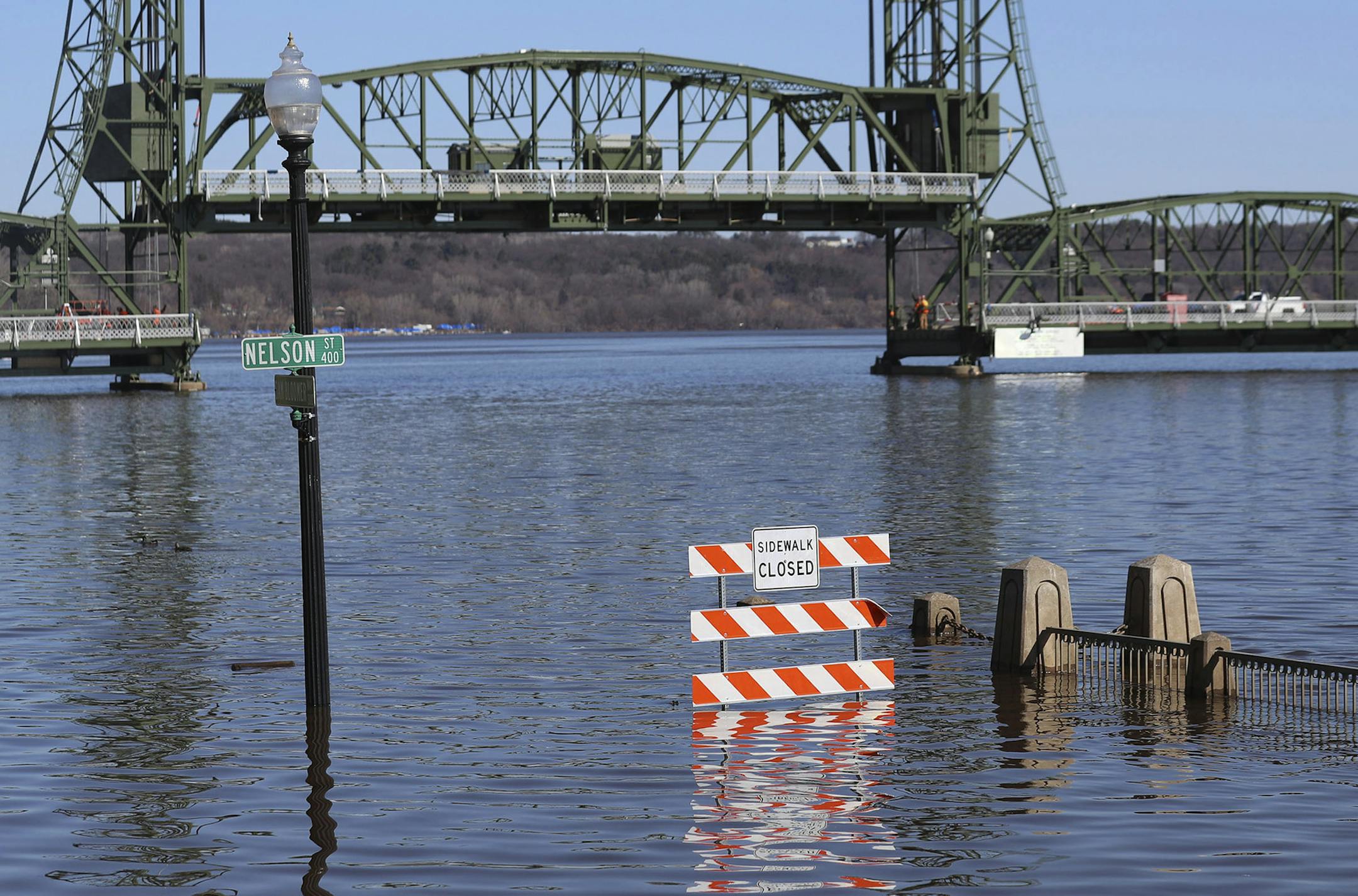 A walkway was underwater with the Stillwater Lift Bridge seen to the rear along the St. Croix River during spring flooding Tuesday March 31, 2020, in Taylors Falls, Minn.