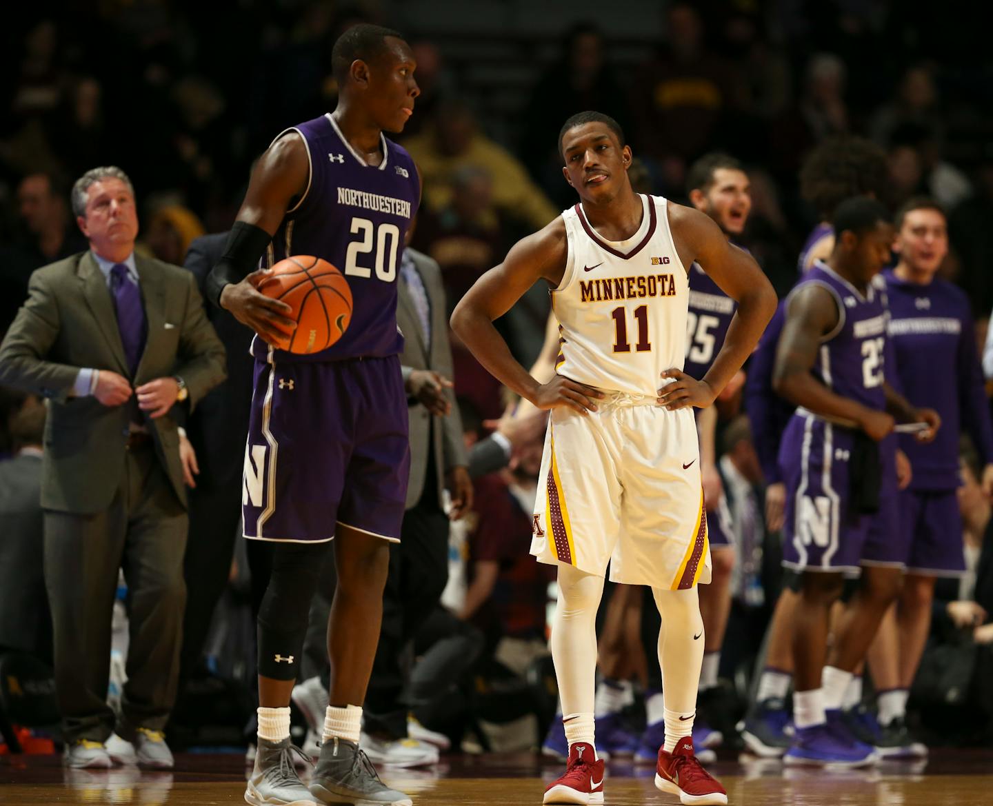 Gophers guard Isaiah Washington stood near Northwestern guard Scottie Lindsey (20) as the clock ran out during the Wildcats' 77-69 victory at Williams Arena on Tuesday night.