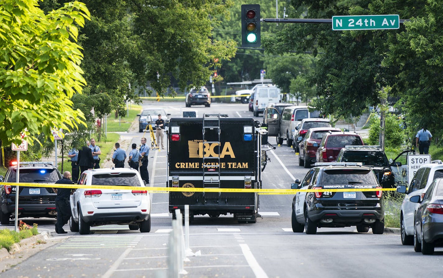 The state Bureau of Criminal Apprehension investigates the scene after Minneapolis police fatally shot a man suspected of shooting and wounding a woman in an apparent domestic dispute, early Friday, Aug. 2, 2019, in Minneapolis. After finding the woman wounded, officers say they repeatedly told the man to drop his weapon and then opened fire, killing him. (Leila Navidi/Star Tribune via AP)