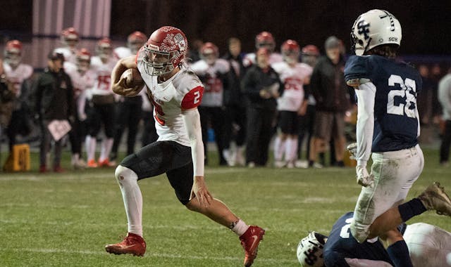 Elk River quarterback Cade Osterman, breaks the tackle of a St. Francis defensive player in the second quarter to score a touchdown in St. Francis .,M