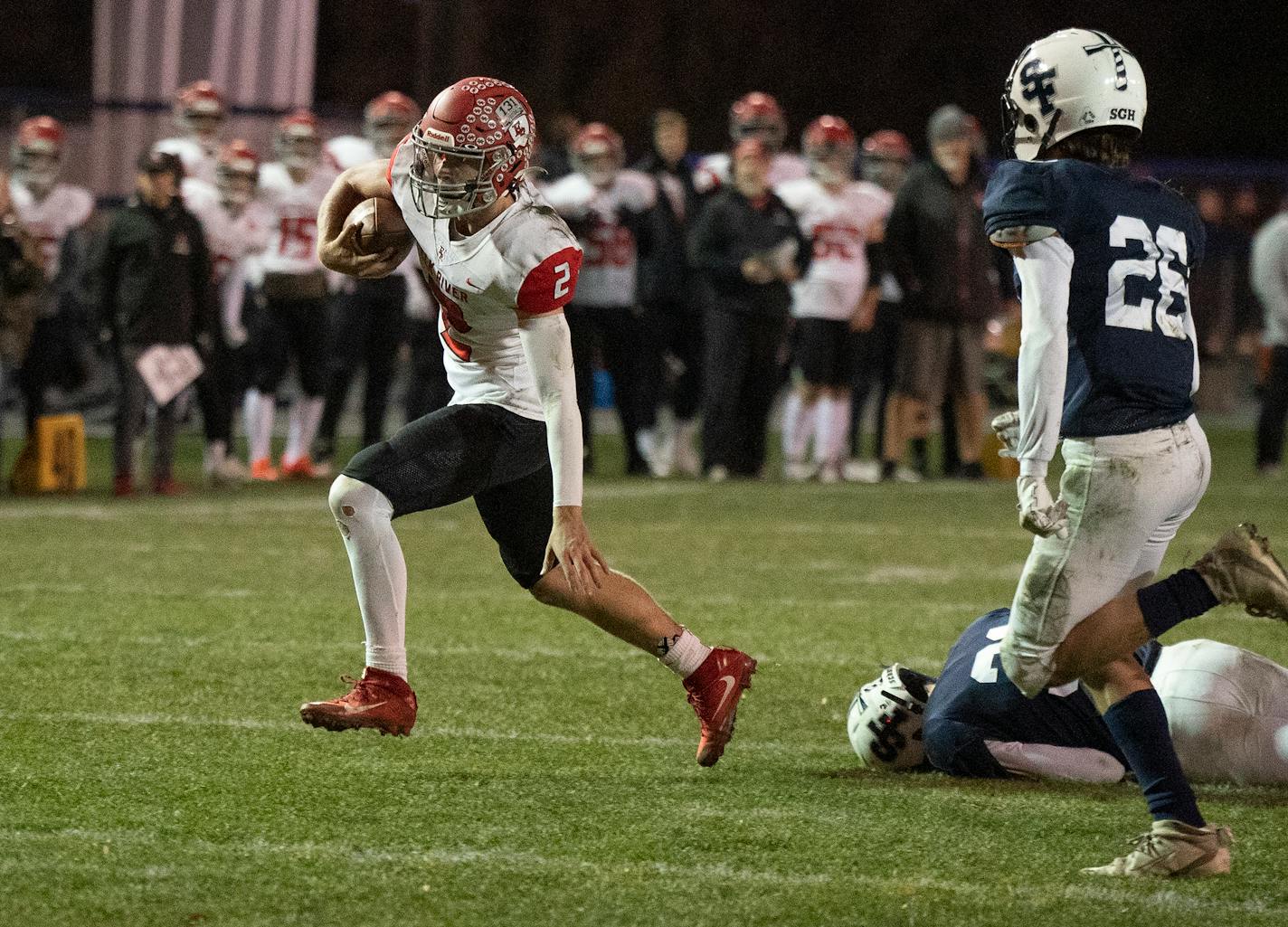 Elk River quarterback Cade Osterman, breaks the tackle of a St. Francis defensive player in the second quarter to score a touchdown in St. Francis .,Minn. on Wednesday October 19, 2022.