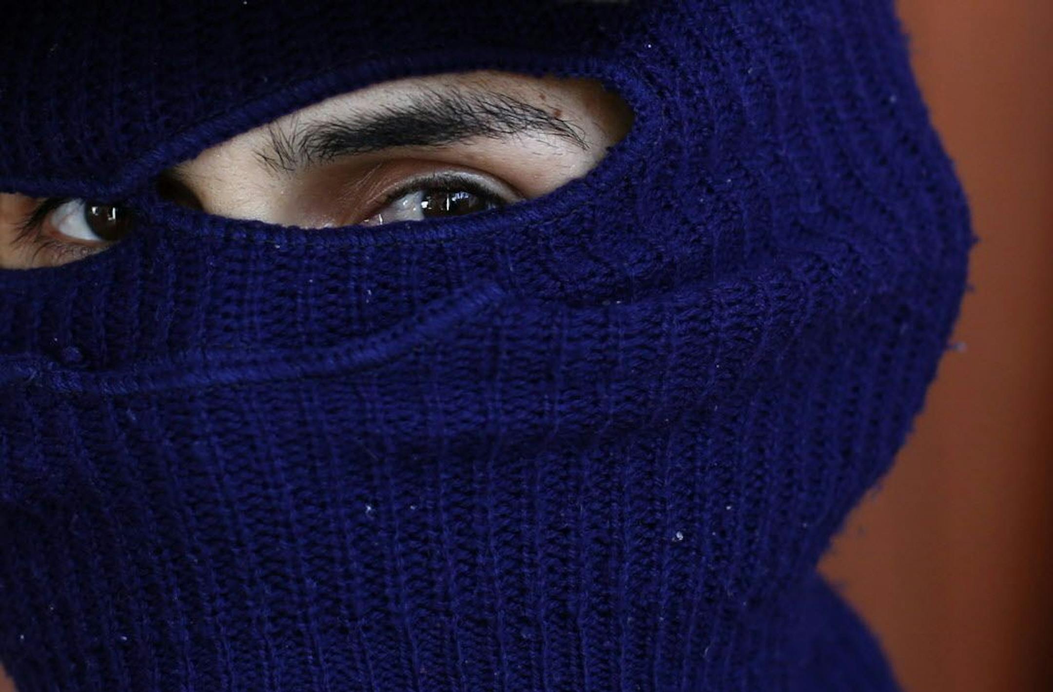 In this Nov. 29, 2015 photo, a man claiming to be responsible for kidnapping, torture and killing on behalf of a drug cartel speaks to the Associated Press in Guerrero state's Costa Grande region, Mexico. The 29-year-old raises cattle for a living and doesn�t consider himself a drug trafficker or a professional killer, although he is paid for disappearing people. While he acknowledges that what he does is illegal, he says he is defending his people against the violence of other cartels.